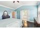Bright bedroom with ensuite bathroom access and dark hardwood floors at 2445 Santa Rosa St, Alpharetta, GA 30009