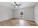 Spacious bedroom featuring wood-look flooring and a ceiling fan at 85 Hickory Dr, Stockbridge, GA 30281