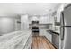 Modern kitchen with white cabinets, granite countertops, and stainless steel appliances at 85 Hickory Dr, Stockbridge, GA 30281