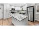 Modern kitchen featuring white cabinets, granite countertops, and stainless steel appliances at 85 Hickory Dr, Stockbridge, GA 30281