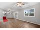 Spacious living room with hardwood floors, a ceiling fan, and access to the kitchen at 85 Hickory Dr, Stockbridge, GA 30281