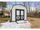 White and black storage shed with a ramp at 85 Hickory Dr, Stockbridge, GA 30281