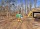 A spacious backyard featuring a wooden deck, a greenhouse, and mature trees at 5295 Ridge Rd, Douglasville, GA 30134