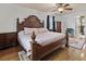 Bedroom features a ceiling fan, a king-size bed, and a glimpse into the bathroom at 5295 Ridge Rd, Douglasville, GA 30134