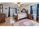 Spacious bedroom with hardwood floors, ceiling fan, large window, and a beautiful area rug at 5295 Ridge Rd, Douglasville, GA 30134