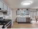 Well-lit kitchen with gray cabinets, stainless steel appliances, and wood-look flooring at 5295 Ridge Rd, Douglasville, GA 30134
