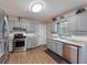 Bright kitchen featuring gray cabinets, stainless steel appliances, and wood-look floors at 5295 Ridge Rd, Douglasville, GA 30134