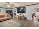 Inviting living room with hardwood floors, television, built-in bookshelves and comfortable tan seating at 5295 Ridge Rd, Douglasville, GA 30134