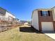 View of the backyard and the side of this brick and vinyl sided home with a one car garage at 8504 Browns Mill Trce, Lithonia, GA 30038