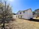 Two story home with white siding and a sloping backyard at 8504 Browns Mill Trce, Lithonia, GA 30038
