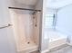 Bathroom featuring a shower and soaking tub with wood-look floors and neutral walls at 8504 Browns Mill Trce, Lithonia, GA 30038
