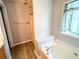 Bathroom featuring a soaking tub, window, and separate shower, creating a relaxing retreat at 8504 Browns Mill Trce, Lithonia, GA 30038