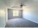 Spacious bedroom with a trey ceiling, carpet, and window, offering comfort and natural light at 8504 Browns Mill Trce, Lithonia, GA 30038