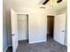 Bedroom with open closet, neutral gray walls, carpet, and white trim at 8504 Browns Mill Trce, Lithonia, GA 30038