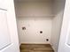 An open closet with a shelf and access to utilities at 8504 Browns Mill Trce, Lithonia, GA 30038
