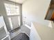Bright entryway with large window above door, chandelier, and staircase with gray carpet at 8504 Browns Mill Trce, Lithonia, GA 30038