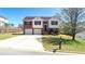 Charming two-story home with a well-manicured lawn, brick accents, and a two-car garage at 8504 Browns Mill Trce, Lithonia, GA 30038