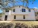 Exterior view of home with white siding and windows, and a walkout basement at 8504 Browns Mill Trce, Lithonia, GA 30038