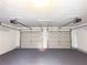 Clean garage with epoxy flooring and two garage doors at 8504 Browns Mill Trce, Lithonia, GA 30038