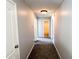 Hallway with neutral colored walls and carpet at 8504 Browns Mill Trce, Lithonia, GA 30038