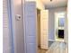 Hallway with wood floors and a view of a bathroom at 8504 Browns Mill Trce, Lithonia, GA 30038