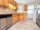 Modern kitchen with stainless steel dishwasher and sink plus a view to the adjacent living spaces at 8504 Browns Mill Trce, Lithonia, GA 30038