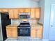 Updated kitchen featuring stainless steel appliances, granite countertops, and wooden cabinets at 8504 Browns Mill Trce, Lithonia, GA 30038
