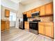 Well-lit kitchen features stainless steel appliances, light wood cabinets, and granite countertops at 8504 Browns Mill Trce, Lithonia, GA 30038