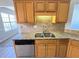 Well-lit kitchen with stainless steel dishwasher, granite countertops, and natural wood cabinets at 8504 Browns Mill Trce, Lithonia, GA 30038