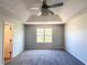 Main bedroom featuring tray ceiling with decorative ceiling fan, fresh paint and new carpet at 8504 Browns Mill Trce, Lithonia, GA 30038