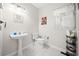 Clean and bright bathroom with pedestal sink and white toilet at 902 College Place Nw Ct, Kennesaw, GA 30144