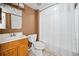 Basement bathroom with shower/tub combo and wood vanity at 902 College Place Nw Ct, Kennesaw, GA 30144
