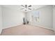 Spacious bedroom with ceiling fan and neutral carpeting at 902 College Place Nw Ct, Kennesaw, GA 30144