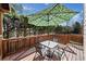 Deck with patio furniture and umbrella, providing an outdoor oasis at 902 College Place Nw Ct, Kennesaw, GA 30144