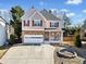 Two-story house with stone accents and a large driveway at 902 College Place Nw Ct, Kennesaw, GA 30144