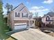 Two-story house with stone accents and a spacious driveway at 902 College Place Nw Ct, Kennesaw, GA 30144