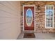 Elegant front door with stone surround and welcome mat at 902 College Place Nw Ct, Kennesaw, GA 30144