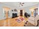 Living room with hardwood floors, fireplace and built-in shelving at 902 College Place Nw Ct, Kennesaw, GA 30144