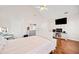 Main bedroom with hardwood floors and a large TV at 902 College Place Nw Ct, Kennesaw, GA 30144