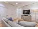 Spacious basement Gathering room with comfortable sofa and media console at 235 Founders Mill Ct, Roswell, GA 30075