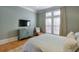 Light and airy bedroom with wood floors and a wall-mounted TV at 235 Founders Mill Ct, Roswell, GA 30075