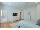 Light-filled bedroom with hardwood floors, a dresser, and ensuite bathroom at 235 Founders Mill Ct, Roswell, GA 30075