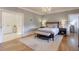 Bright bedroom with hardwood floors, plush bedding, and access to a private bathroom at 235 Founders Mill Ct, Roswell, GA 30075