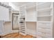 Spacious walk-in closet with built-in shelving and drawers at 235 Founders Mill Ct, Roswell, GA 30075