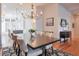 Elegant dining room featuring a chandelier, hardwood floors and spacious seating for eight at 235 Founders Mill Ct, Roswell, GA 30075