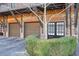 Brick townhome with 2-car garage and landscaped entry at 235 Founders Mill Ct, Roswell, GA 30075