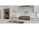 Modern kitchen boasts a stainless steel range and stylish backsplash at 235 Founders Mill Ct, Roswell, GA 30075
