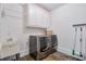 Laundry room with washer, dryer, cabinets, and utility sink at 235 Founders Mill Ct, Roswell, GA 30075