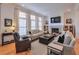 Spacious living room with hardwood floors, fireplace, and ample seating at 235 Founders Mill Ct, Roswell, GA 30075