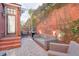 Cozy patio with brick flooring, wicker furniture, and a grill at 235 Founders Mill Ct, Roswell, GA 30075